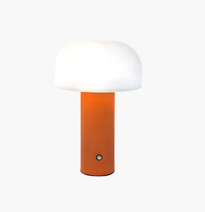 Modern table lamp with an orange cylindrical base and a white dome-shaped shade.