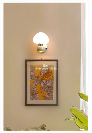 Framed artwork featuring stylized leaf patterns in orange and brown tones.