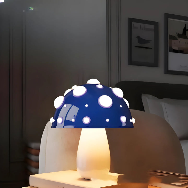 Mushroom-shaped lamp with a blue cap dotted with white spots.