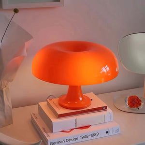 Bright orange mushroom-shaped table lamp with a rounded dome shade.