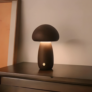 Mushroom-shaped table lamp with a dark dome top and glowing base.