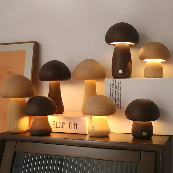 Collection of mushroom-shaped lamps glowing warmly on a surface.