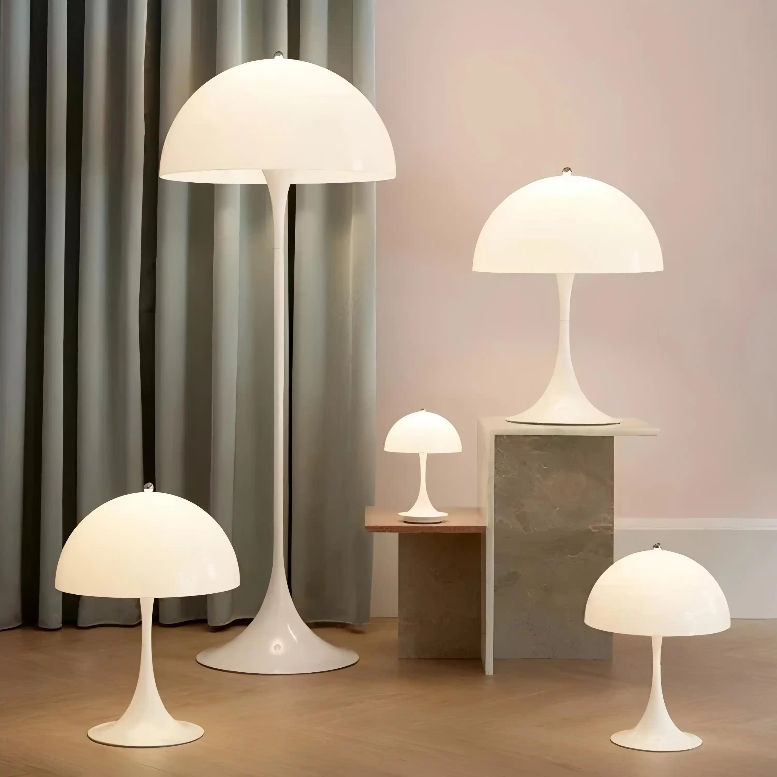 Collection of white mushroom-shaped table and floor lamps with domed shades.