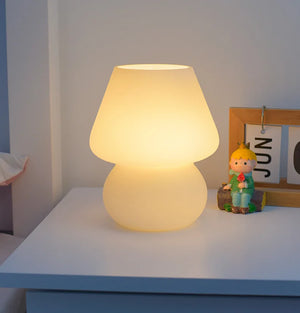 Glowing mushroom-shaped table lamp with a warm, soft light.