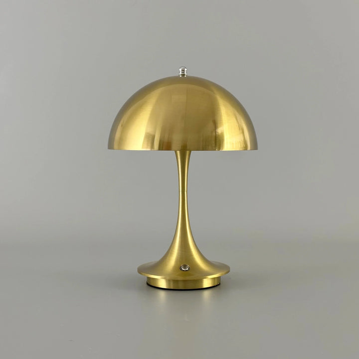 Gold-colored mushroom-shaped table lamp with a domed shade.