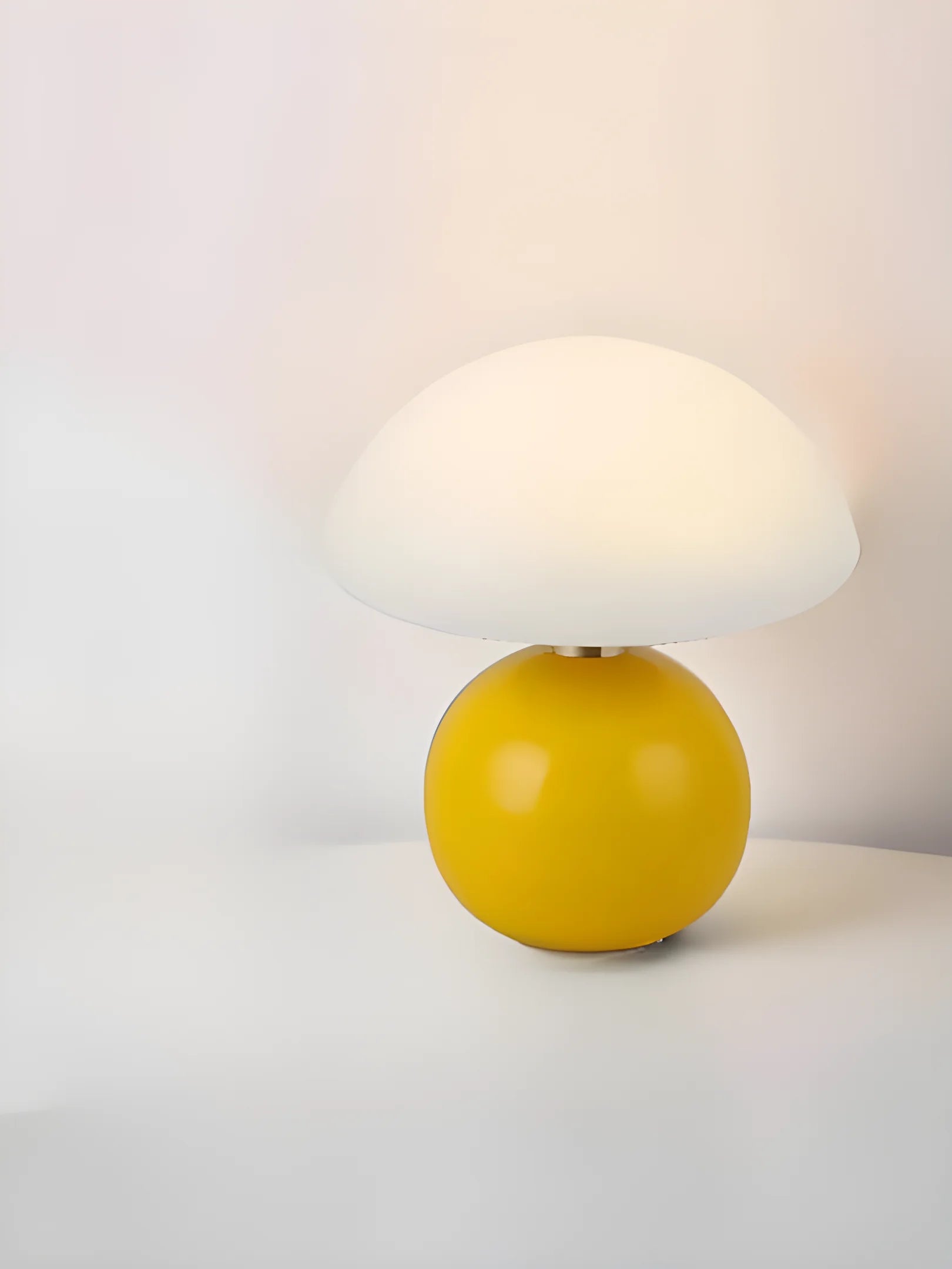 Yellow spherical lamp with a white dome-shaped shade.