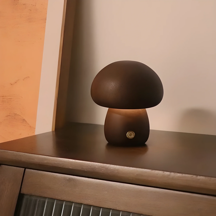 Mushroom-shaped lamp with a dark brown cap and stem on a surface.