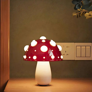 Mushroom-shaped lamp with a red cap dotted with white spots.