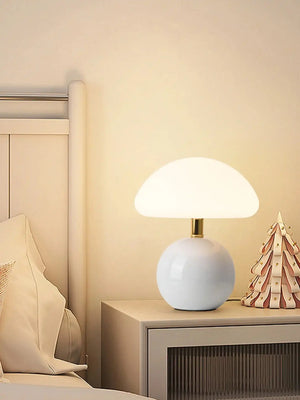 Mushroom-shaped table lamp with a white spherical base and domed shade.