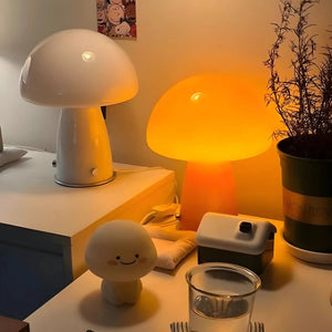 Mushroom-shaped table lamps with glowing white and orange domes.