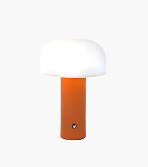 Modern table lamp with an orange cylindrical base and a white dome-shaped shade.