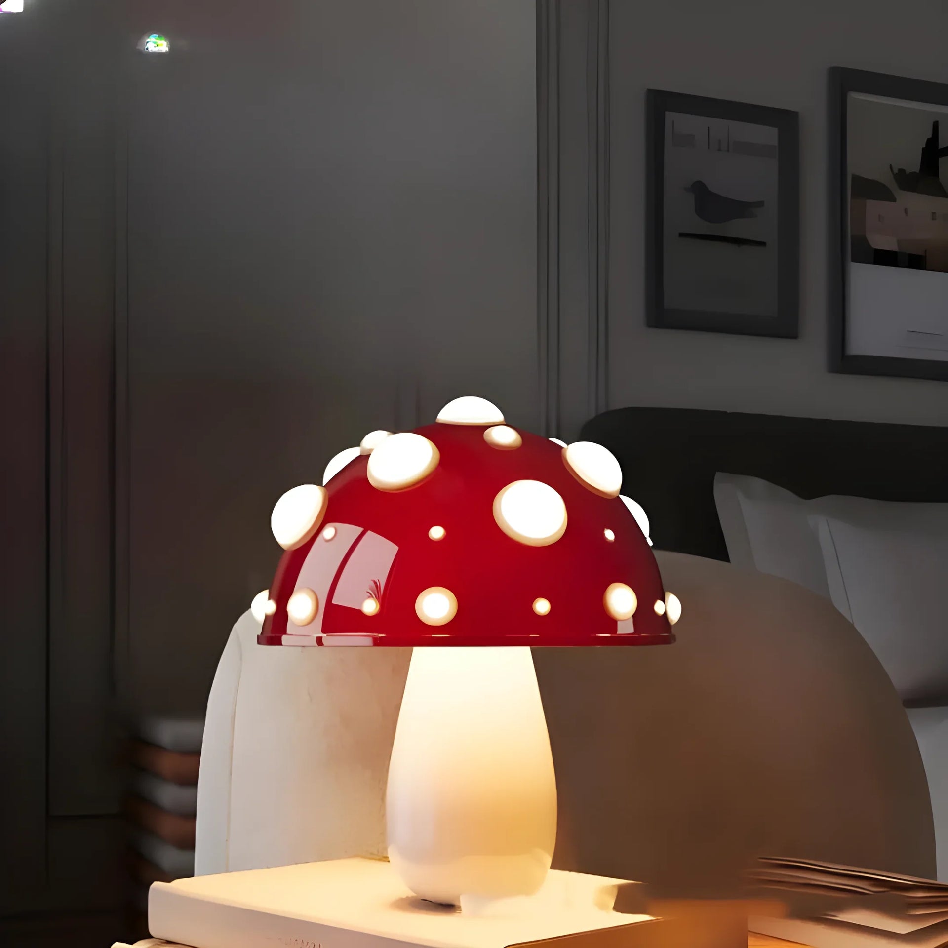 Whimsical mushroom-shaped table lamp with a red cap and white spots.