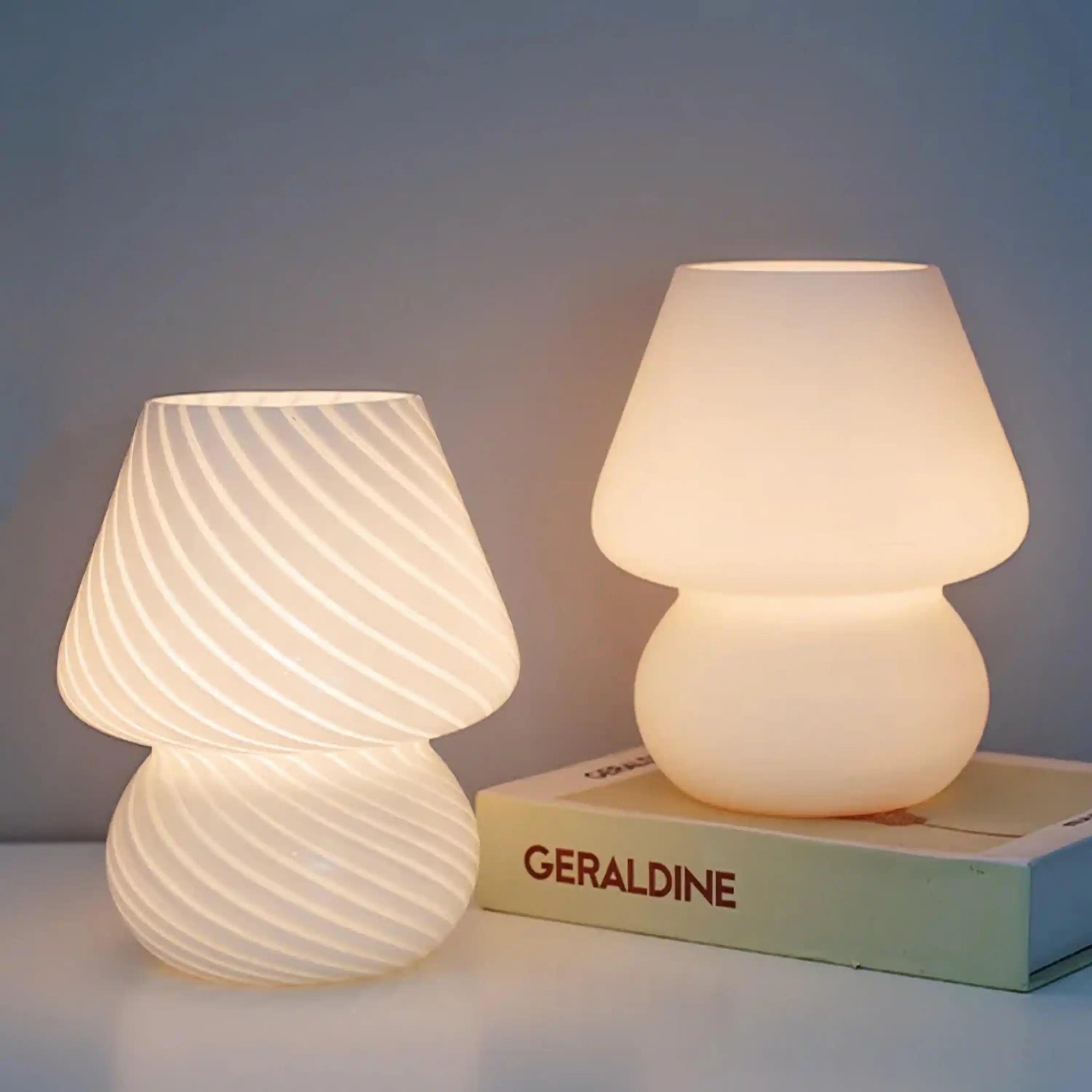 Two illuminated mushroom-shaped table lamps with textured glass shades.