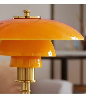 Vibrant orange and gold retro-style table lamp with a layered shade design.