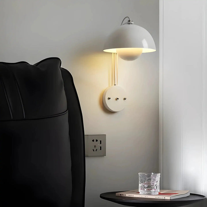 Wall-mounted dome lamp with a white shade and circular base.