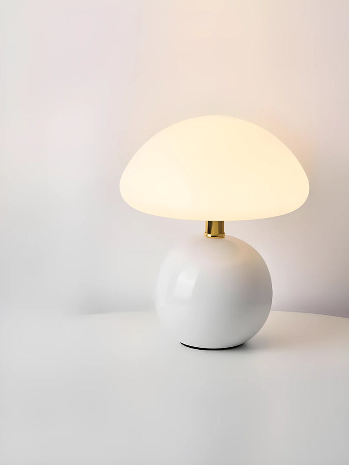 Mushroom-shaped table lamp with a white spherical base and domed shade.