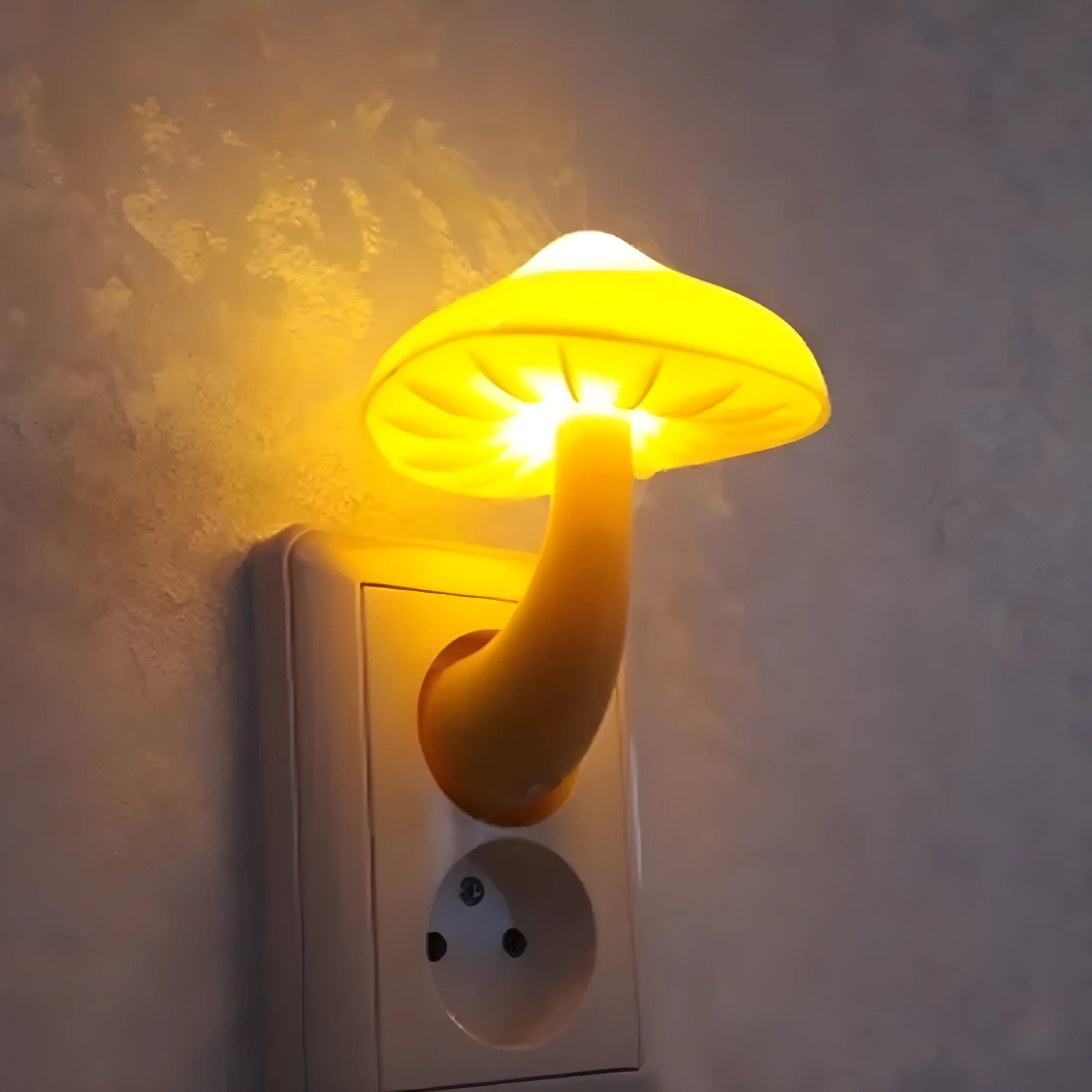 Glowing yellow mushroom-shaped night light plugged into an electrical outlet.