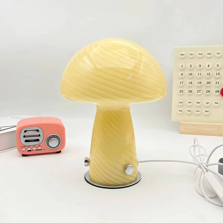 Yellow mushroom-shaped table lamp with a rounded cap and stem-like base.