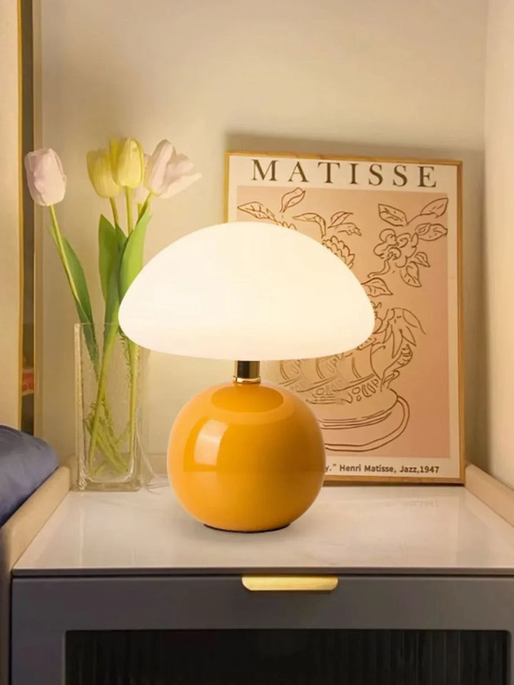 Spherical yellow lamp with a white dome shade.